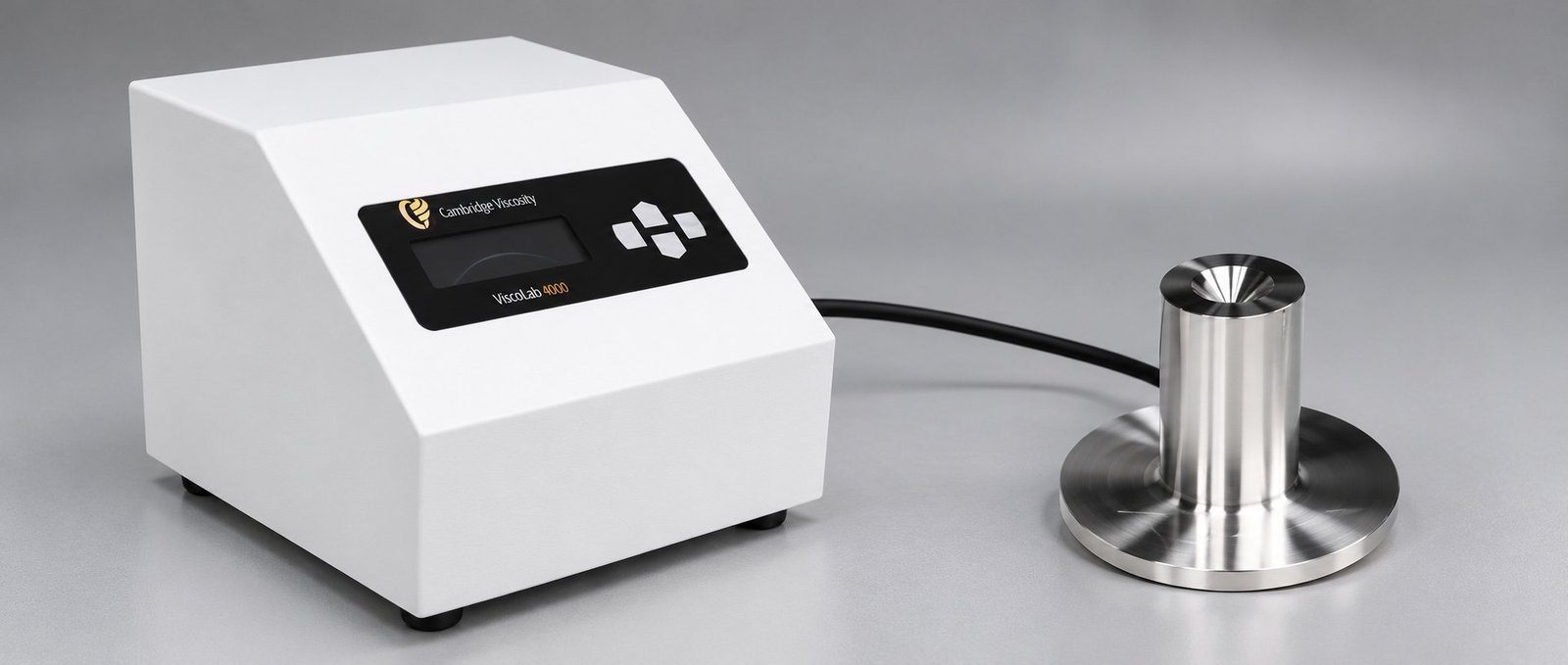 Viscometer Measurement Setup Close view of a white benchtop viscometer control panel and polished metal measuring vessel